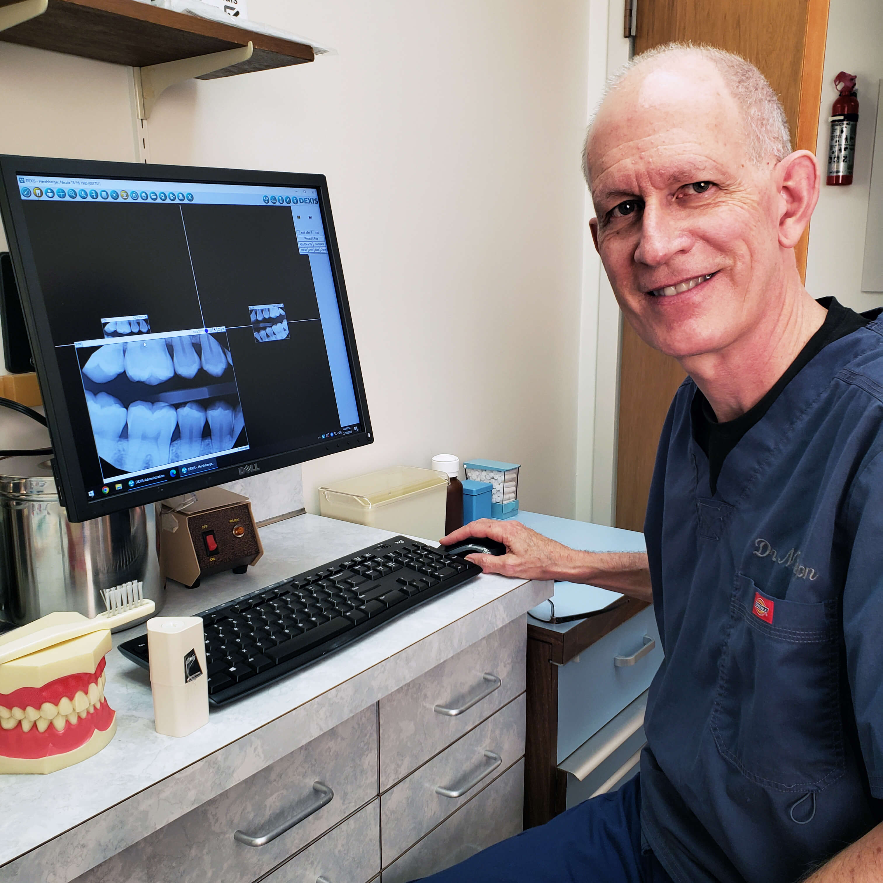 dentist smiling in his office in Connecticut